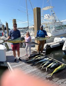 Three people enjoying a fishing trip on the coast of Kiawah Island