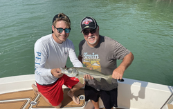 Snook fish caught by two people in FL