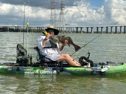 Solid black drum kayak catch on the river