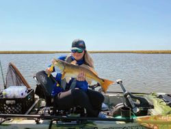 An angler reels in a 22-inch fish at Crosby