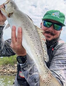 A lone angler reels in a catch in the great outdoors of TX.