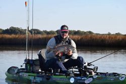 Angler holding a redfish caught in Crosby