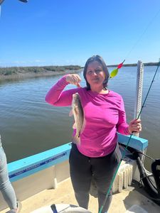 Angler holding 12-inch redfish in Darien