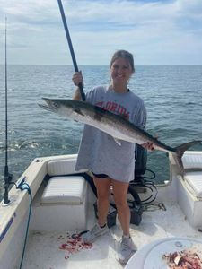 A fisherman holding a Spanish Mackerel in Darien