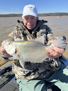 A lone fisherman reeling in a sizable catch in the MS region