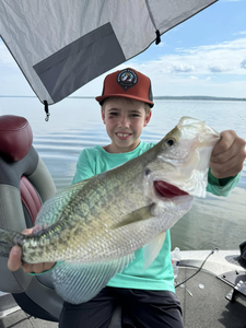 A lone angler holding a 24-inch fish in MS