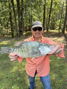 A lone angler fishing in Pope, holding a 24-inch catch.