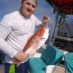 A lone fisherman reeling in a catch in St. Marys