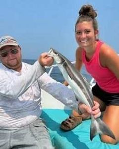 A fisherman holding a 13-inch fish in St. Marys