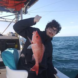 Fisherman standing in water in GA with fishing gear