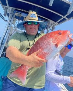 Fisherman holding a 16-inch fish in St. Marys