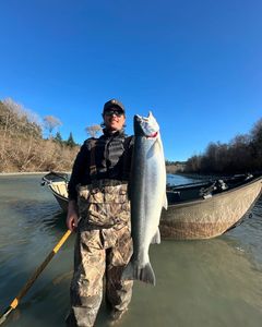 A person fishing for a pink salmon in Oregon