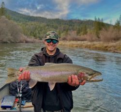 A person fishing for a rainbow trout in Oregon
