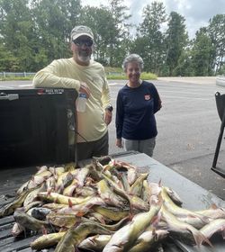 Two people fishing at Kowaliga location