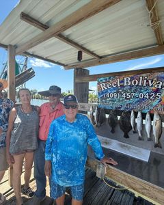 Three people enjoying a fishing trip on the Bolivar Peninsula