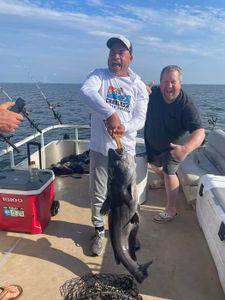 Two people fishing with a 29-inch catch at a cross location