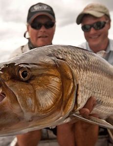 Two people fishing on the beach in Florida