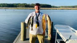 A person fishing with 2 big fish at Santa Rosa Beach