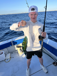 Catching the big one on a gorgeous day out on the open waters.