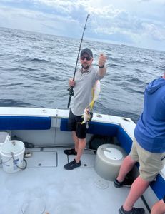 A single fisherman reeling in a catch in Florida