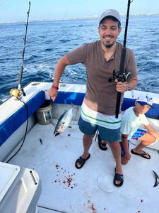 Two people enjoying a fishing tour in West Palm Beach