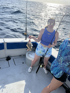 Hooking the big one on a sunny day out at sea.