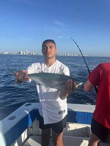 Reeling in an 18-inch Little Tunny under partly cloudy skies!