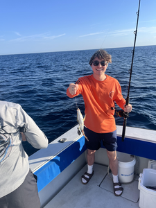 Reeling in another catch out on the open sea.
