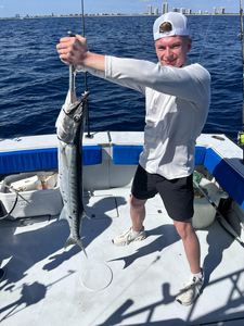 Reeling in a big one on the open water.