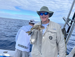 Reeling in the big one on the open waters.
