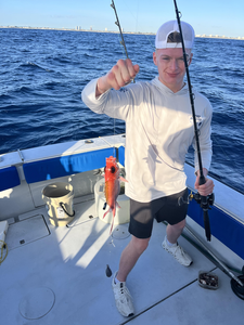 Reeling in the catch on a serene day at sea.