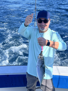 Reeling in a good one on the open sea.