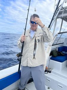 Reeling in a good one out on the open water.