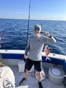 Reeling in a good one out on the open sea.