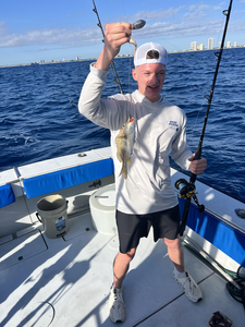 Reeling in a good one out on the open water.