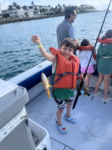 Reeling in a good one on a sunny day by the coast.