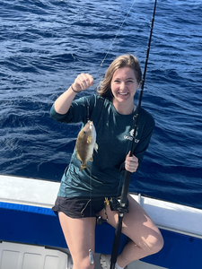 Reeling in a great catch out on the open sea.
