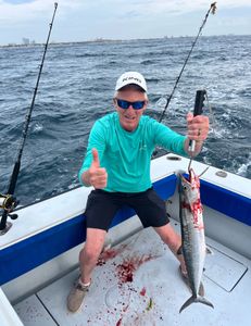 Angler reeling in a Spanish mackerel fish in West Palm Beach