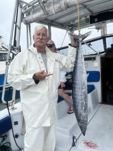 A massive wahoo fish caught off the coast of West Palm Beach on a day with partly cloudy skies and morning rain.
