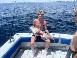 Reeling in the big one under partly cloudy skies in West Palm Beach!
