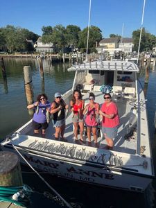 Successful fishing charter in Oxford MD with fresh catch displayed on boat deck
