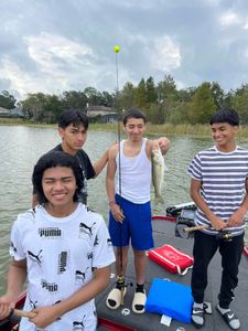 Fishing trip in Tavares FL with fresh caught bass displayed on boat