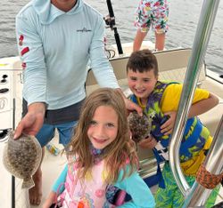 Angler holding a summer flounder fish in Tuckerton