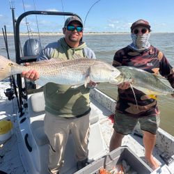 Two anglers display redfish and crevalle jack caught while fishing in Rockport TX on boat