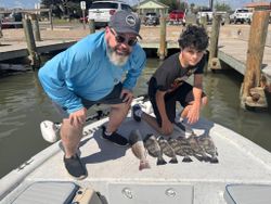 Fresh caught redfish and black drum displayed on boat deck in Rockport TX