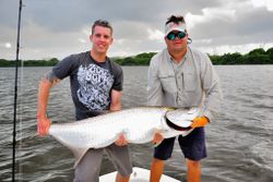 Angler with a large tarpon fish in PR