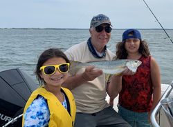 Three anglers fishing in New York with one fish