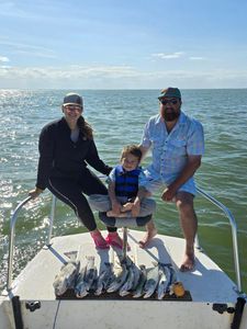 Three people enjoying fishing trip in TX