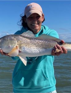 Anglers catching an Atlantic Croaker fish in Texas