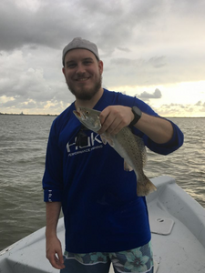 A lone fisherman reeling in a catch in Texas